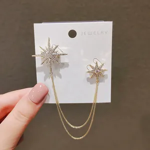 Elegant gold starburst jewelry pins with dual delicate chains and sparkling stones