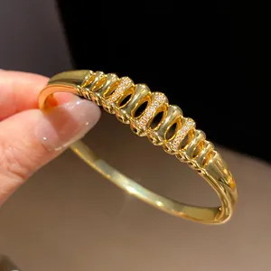 Detailed view of luxury 18k gold plated geometric bracelet with micro zircons