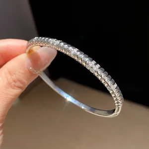 Detail view of 18k gold plated silver bangle with ridged texture and sparkling zircons