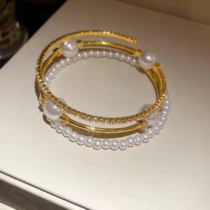 Close-up of elegant triple-layer bangle with pearls and sparkling rhinestones