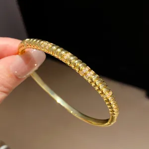 Detailed close-up view of elegant 18k gold plated ribbed bangle featuring zircon stones