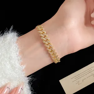 Detailed macro view of a sparkling 18k gold plated cubic zirconia Cuban link bracelet on a wrist