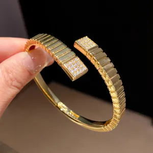 Close-up of 18k gold-plated geometric bangle with sparkling zircon square accents