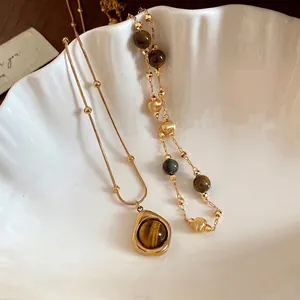 Exquisito collar vintage de cuentas de ojo de tigre con colgante de gota en acabado dorado