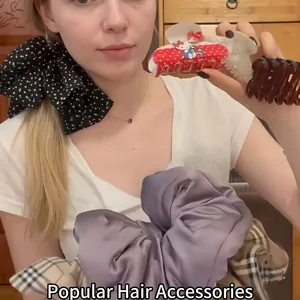 Elegant Korean style hair accessory set featuring a satin scrunchie and a bow hair clip