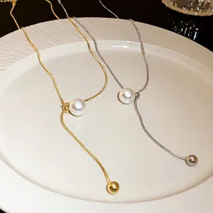 Elegant adjustable pearl tassel snake chain necklace featuring gold and silver finishes