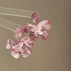 Detail shot of elegant pink marbled resin flower earrings with s925 silver needle