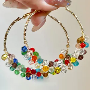 Vibrant multi-colored crystal bead hand-wrapped large hoop earrings with golden wire