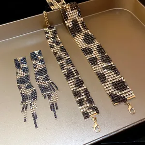 Macro detail view of leopard print rhinestone necklace, bracelet and fringe earrings set.
