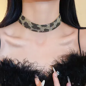 Detailed view of a wide leopard print choker necklace featuring sparkling rhinestones on model