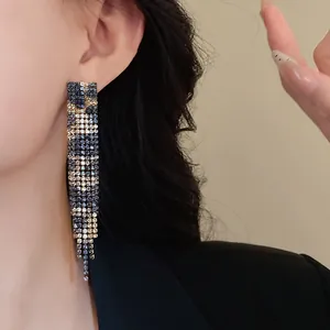 Detailed view of luxury vintage leopard print rhinestone tassel dangling earrings on a model.