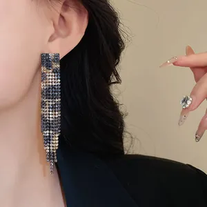Elegant dangling leopard print rhinestone rectangle earrings shown on model's ear
