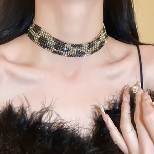 Detailed view of a wide rhinestone leopard print choker necklace worn by a model