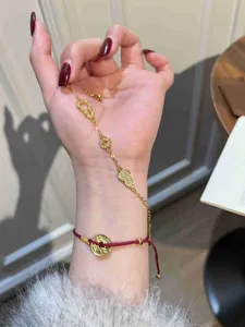 Detailed view of a 24K gold plated bracelet featuring zircon gourd and coin charms
