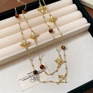 Vintage gold long necklace with diamond cross pendants and brown tiger eye beads