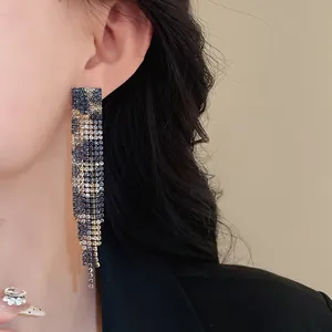 Close-up of leopard print rhinestone long earrings showing sparkling detail and texture.