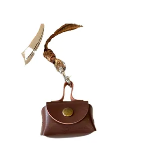 Stylish mini brown leather coin purse necklace pendant featuring a long rope strap design