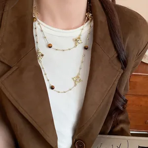 Vintage double-layered long necklace with rhinestone cross charms and tiger eye beads