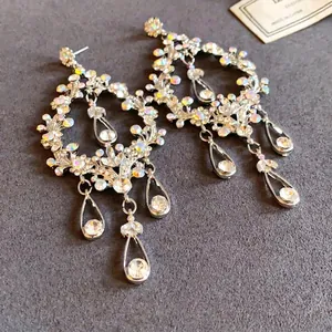Intricate silver needle dangle earrings with hollow waterdrop tassels and AB rhinestones