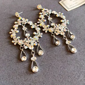 Close-up detail of silver-tone rhinestone hollow teardrop tassel earrings for evening gala