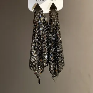 Detailed view of vintage silver metal sequin tassel earrings with triangular stud design