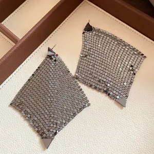 Detailed view of gunmetal metallic mesh diamond-shaped earrings in a jewelry tray