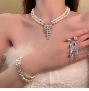 Elegant double-strand pearl and rhinestone jewelry set featuring necklace earrings bracelet