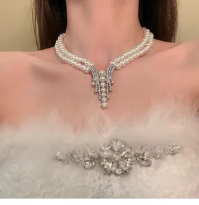 Detailed view of French style double-layer pearl necklace with rhinestone pendant on neck