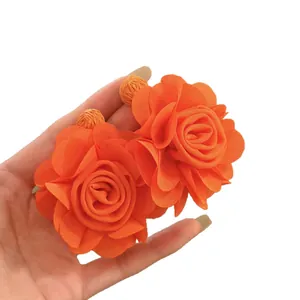 Vibrant orange chiffon flower stud earrings featuring elegant layered fabric petals