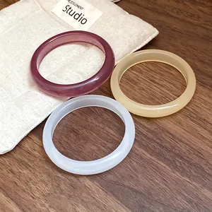 Set of three minimalist resin bangles in burgundy amber and white for a chic look