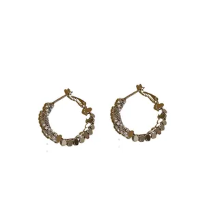 Elegant silver needle hoop earrings with sparkling cubic zirconia and golden accents