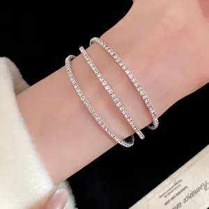 Elegant three-layer silver open bangle bracelet decorated with sparkling white rhinestones