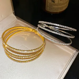 Detail view of gold and silver triple-layer crystal open bracelets for women