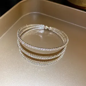 Elegant silver-toned three-layer open bangle set with sparkling rhinestones on tray