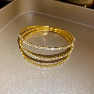 Elegant triple-layer gold plated open bangle embellished with sparkling clear rhinestones