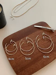 Comparison of three sizes for minimalist silver metal hoop earrings: 4cm, 5cm, and 6cm.