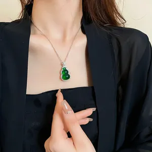 Close-up view of a green resin gourd pendant necklace with zircon on a model.