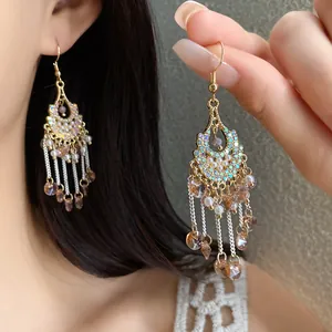 Close-up detail of bohemian tassel earrings with sparkling rhinestones and pearls