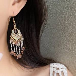 Close-up detail of vintage Bohemian tassel earrings featuring sparkling rhinestones and pearls