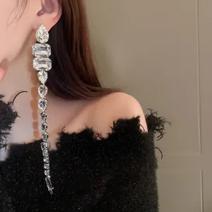 Eleganti orecchini lunghi a nappa di cristallo con pietre a goccia scintillanti su modella.