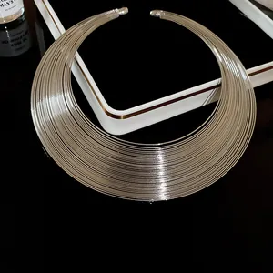 Close-up of silver multi-layer metallic geometric necklace with industrial design.