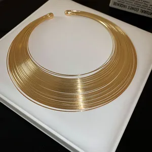Exquisite close-up of an elegant multi-layered gold metal collar necklace for women