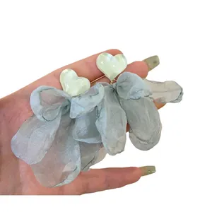Elegant heart-shaped stud earrings with oversized light blue chiffon flower petals.
