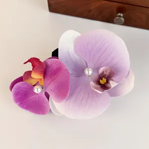 Sweet orchid floral hair clip featuring elegant pearl embellishments in soft lavender purple