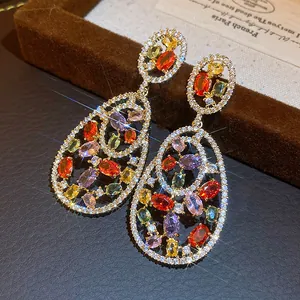 Close-up of vintage teardrop earrings with colorful gemstones and zircon paving