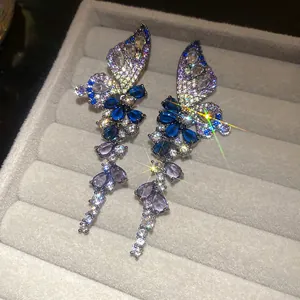Detailed close-up of vintage butterfly earrings with gradient blue and purple zircons