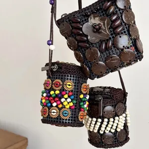 Handmade Bohemian coconut shell pouch necklace with ethnic bead details and retro style