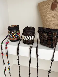 Detail of Bohemian ethnic mini coin pouches featuring colorful beads and coconut shell