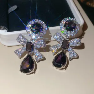 Exquisite vintage style purple zircon bow and flower drop earrings with brilliant starburst.
