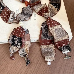 Vintage pleated fabric necklace with bandana print, pearl and Saturn orb pendant